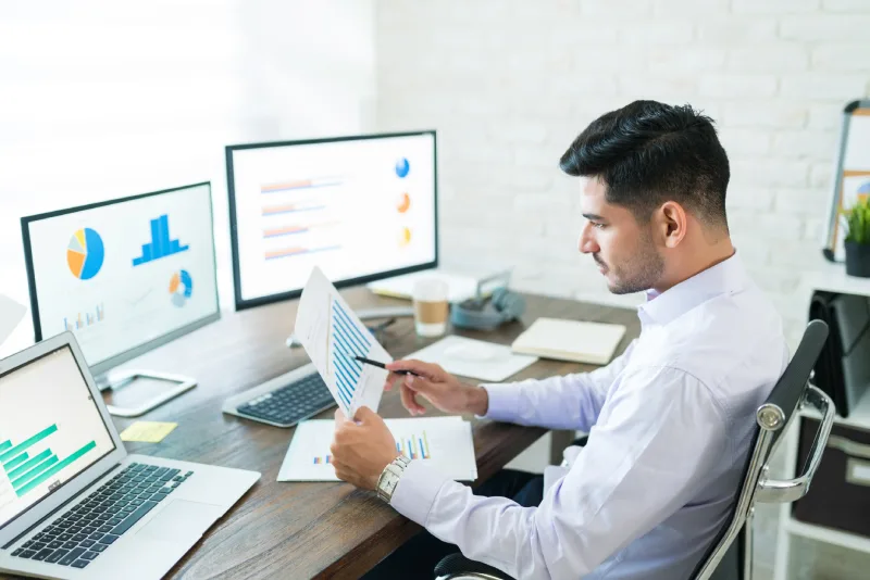 handsome-latin-businessman-examining-sales-data-while-working-home